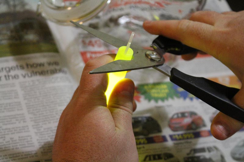 Cutting the end off the glow stick to get to the glowy goo to make the fairy light sparkle!