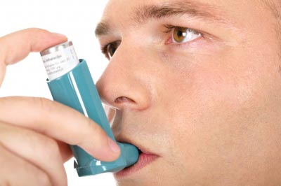 Man using his asthma inhaler. Image courtesy of marin / FreeDigitalPhotos.net