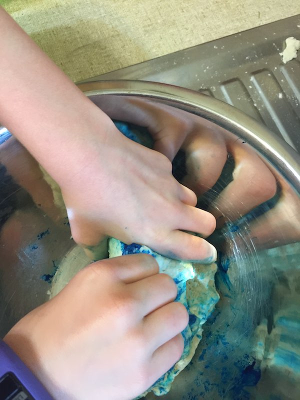 Julia mixing the blue dough.