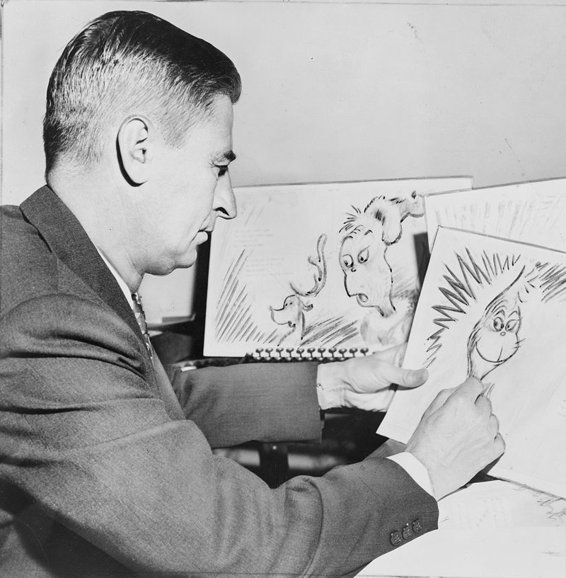 Ted Geisel, American writer and cartoonist, at work on a drawing of the grinch for "How the Grinch Stole Christmas"